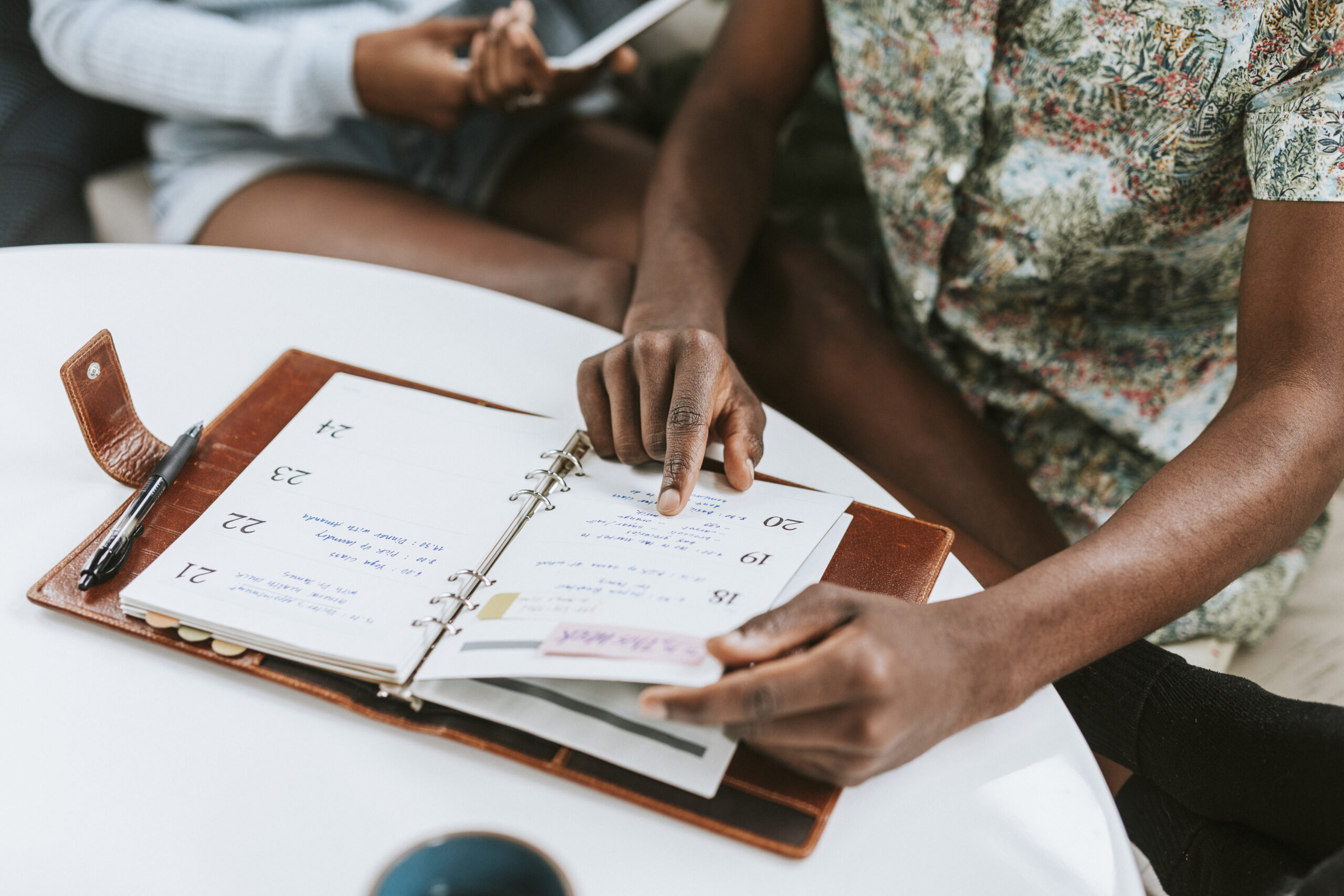 people-planning-with-a-leather-journal-and-planner